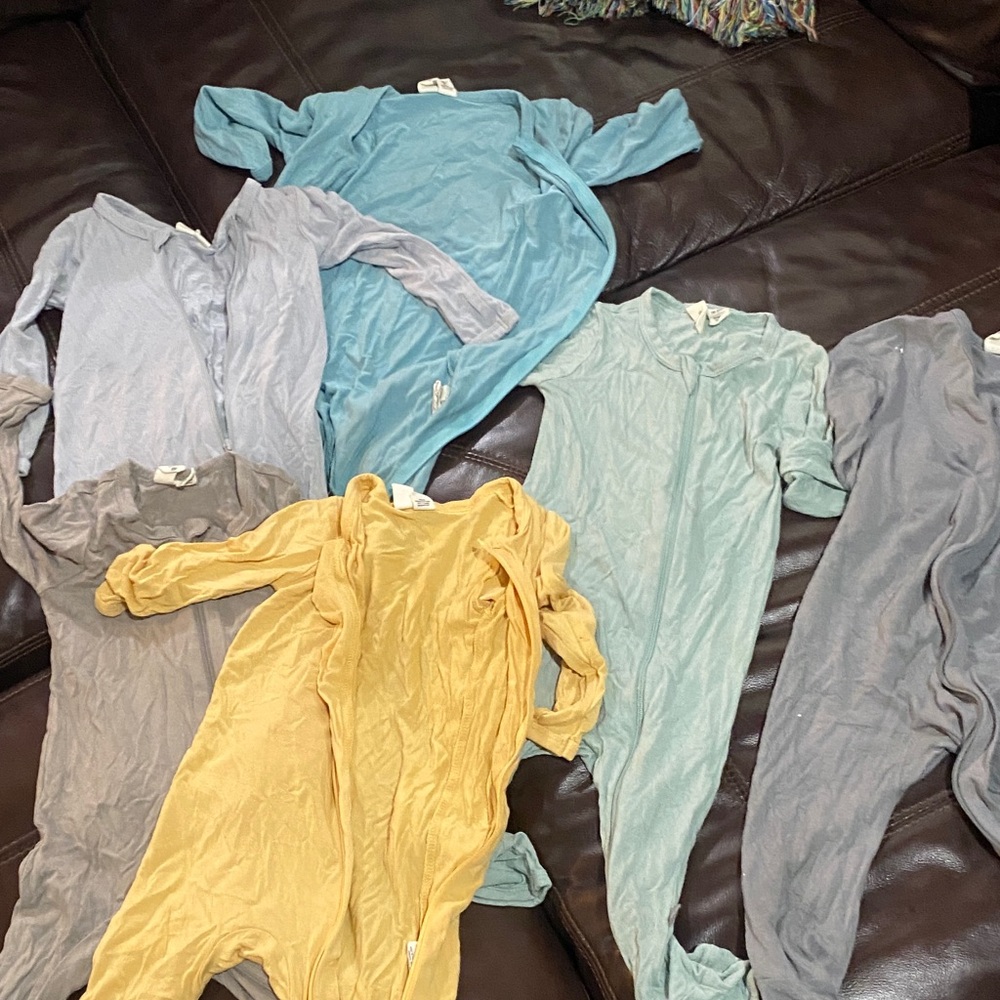 Assorted Kyte baby zipper rompers in Blue, Yellow, and Gray